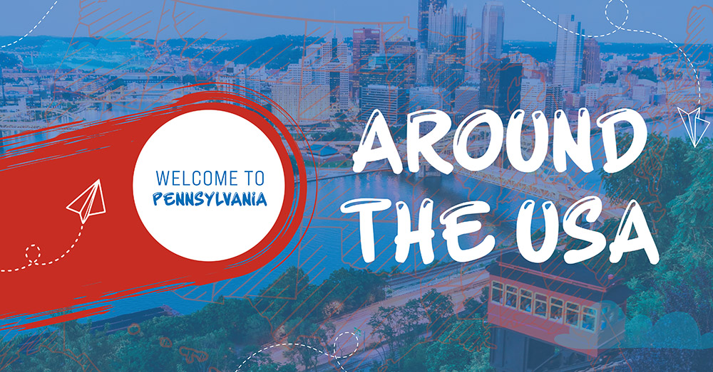 Colorful graphic with text: WELCOME TO PENNSYLVANIA in a white circle on a red stripe, and AROUND THE USA over a cityscape background with blue sky, river, and buildings. A paper airplane illustration appears on the left.