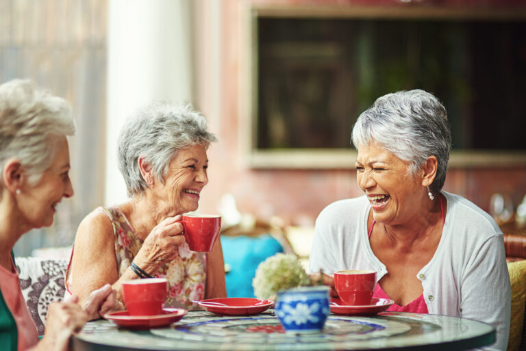a group of senior women enjoying life together in a senior living community