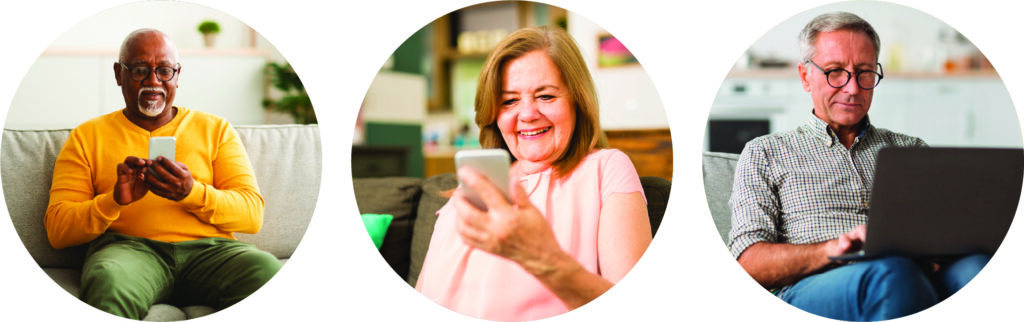 Three older adults sit indoors, each using technology: the first holds a smartphone, the second smiles at her phone, and the third types on a laptop. They appear relaxed and engaged with their devices.