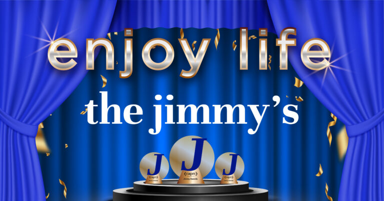 Blue curtains frame a stage with golden confetti and three trophy-like awards labeled JJ. Large, shiny text at the top reads enjoy life, and below, the jimmy’s is written in white.