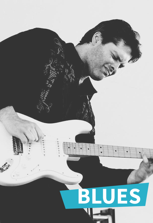 A man playing an electric guitar passionately, with the word BLUES in bold white letters on a blue banner in the bottom right corner. The image is in black and white.