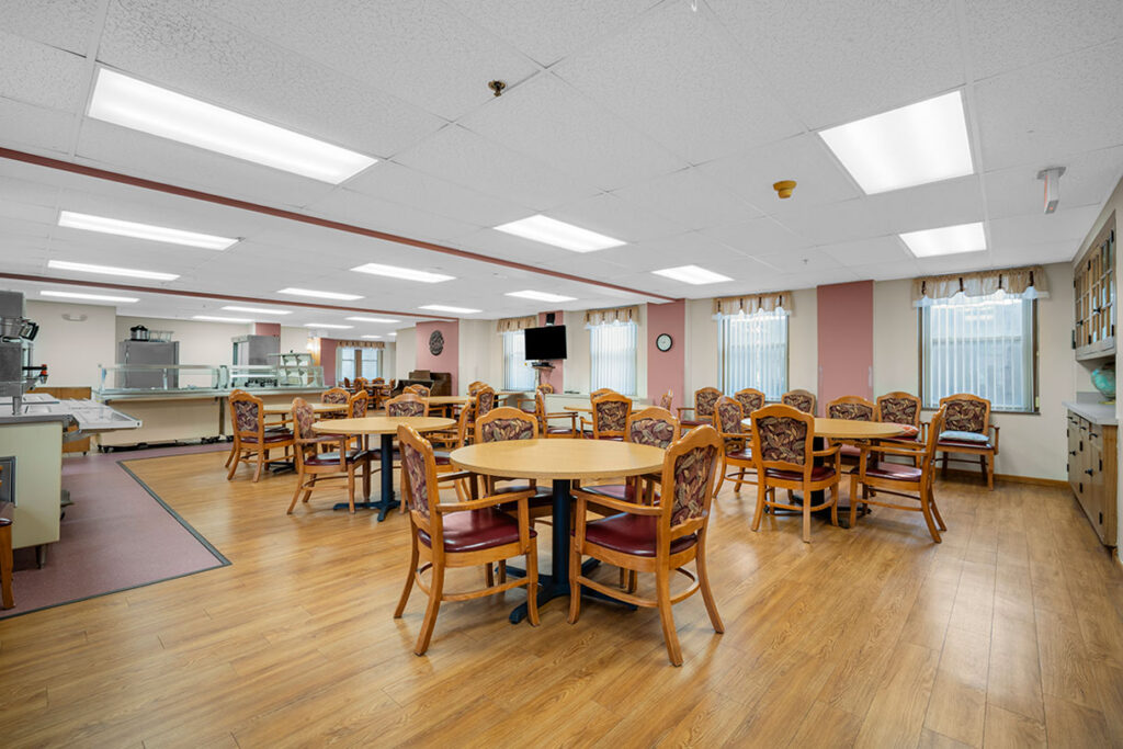 Dining room with tables and buffet counters at senior living community