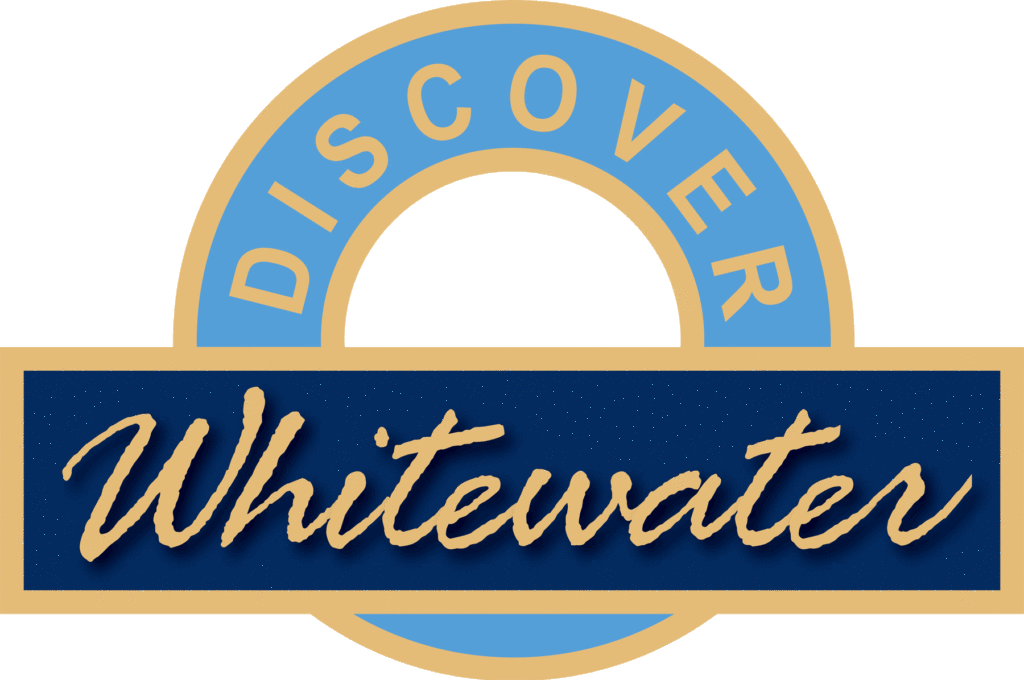 A circular logo with the word DISCOVER in gold on a light blue ring, and a dark blue rectangle across the center featuring the word Whitewater in gold script. The logo has a gold border.