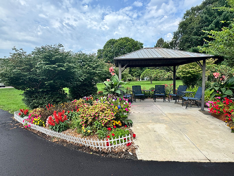 Front gazebo with flowers in bloom at Juniper Court senior living community