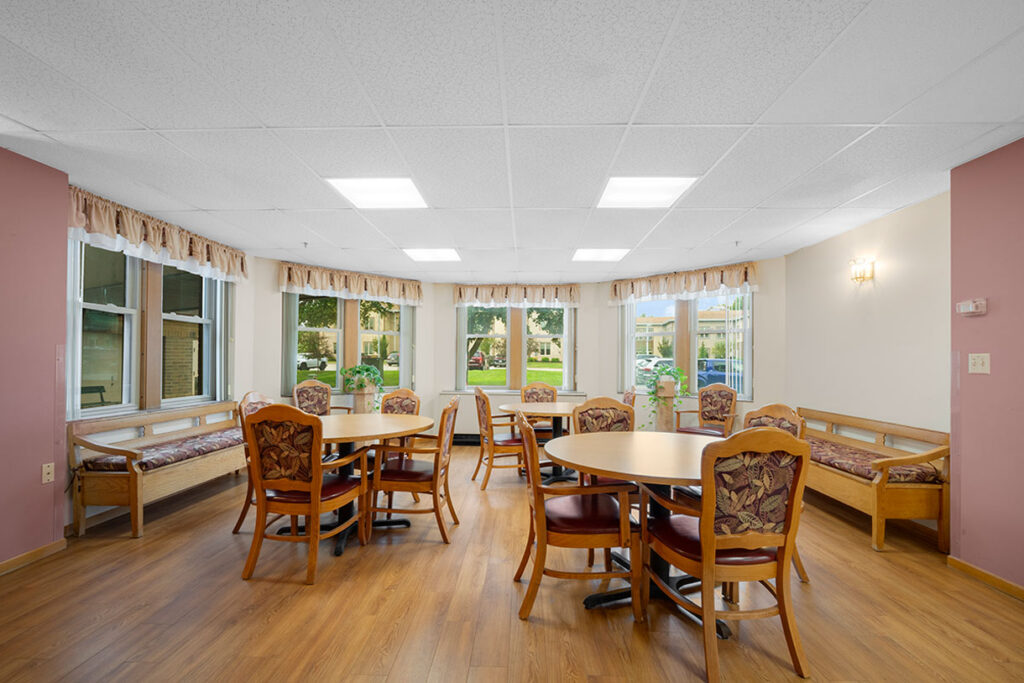 Juniper Court Senior Living Community Gathering Place with tables, chairs and benches
