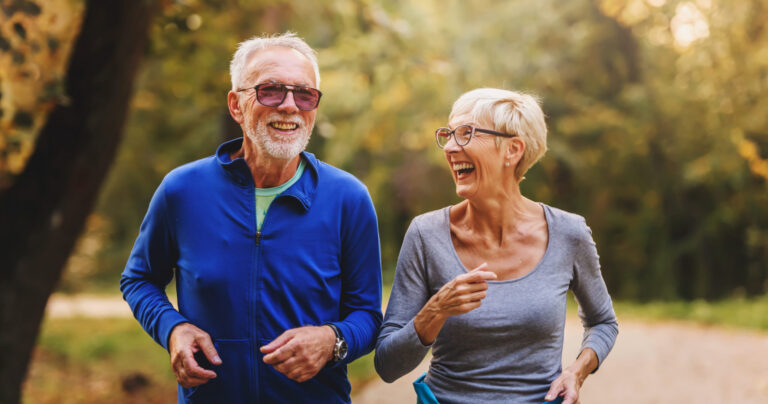Two seniors out for a healthy fall walk to boost their immune systems.
