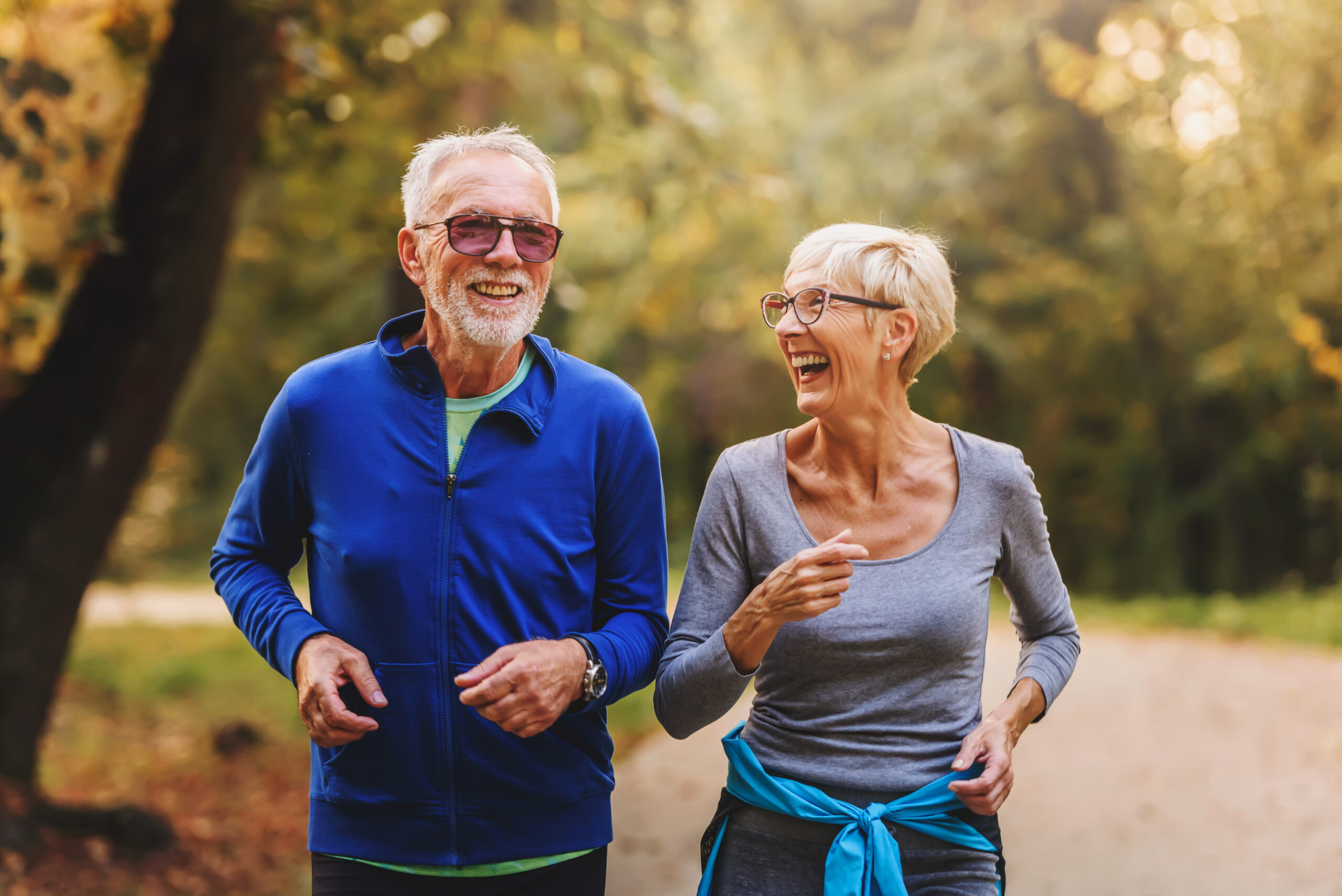 Two seniors out for a healthy fall walk to boost their immune systems.