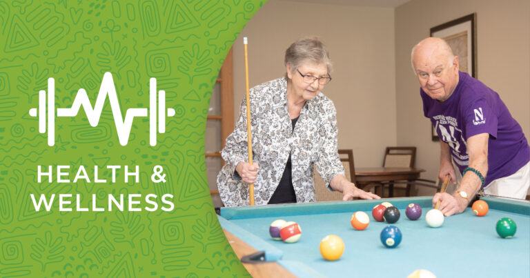 Two older adults, one holding a pool cue, enjoy billiards together—highlighting activities for cognitive health. On the left, a green graphic displays a heartbeat line, dumbbells, and the words Health & Wellness.