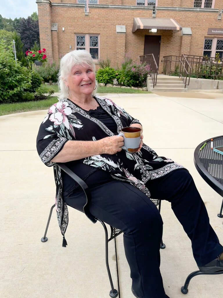 Senior Living Resident enjoying coffee on the patio