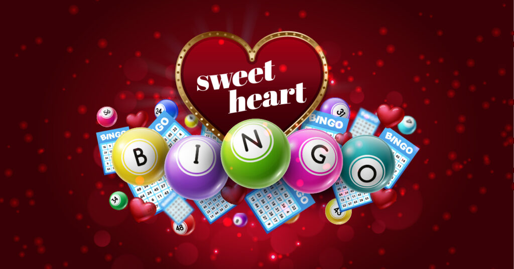 Colorful bingo balls, bingo cards, and small red hearts surround a large heart-shaped sign that says sweet heart on a red, glowing background with scattered light spots.