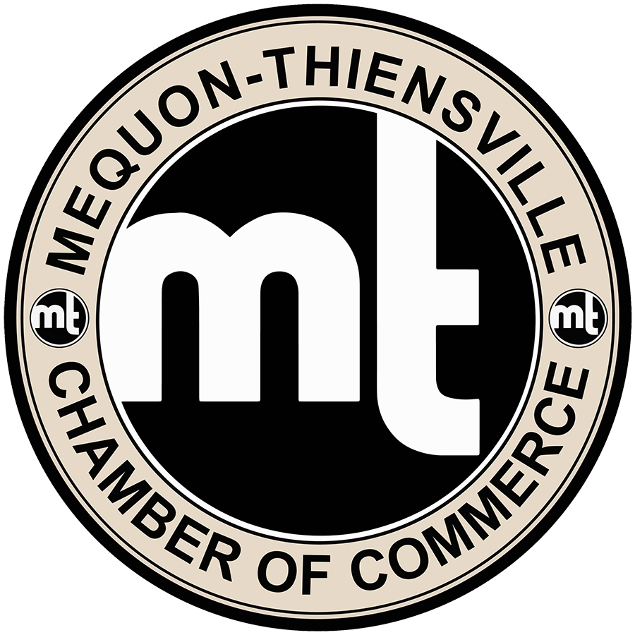 Round logo featuring the letters mt in lowercase at the center, with MEQUON-THIENSVILLE CHAMBER OF COMMERCE written around the edge and two small mt circles on either side of the border.